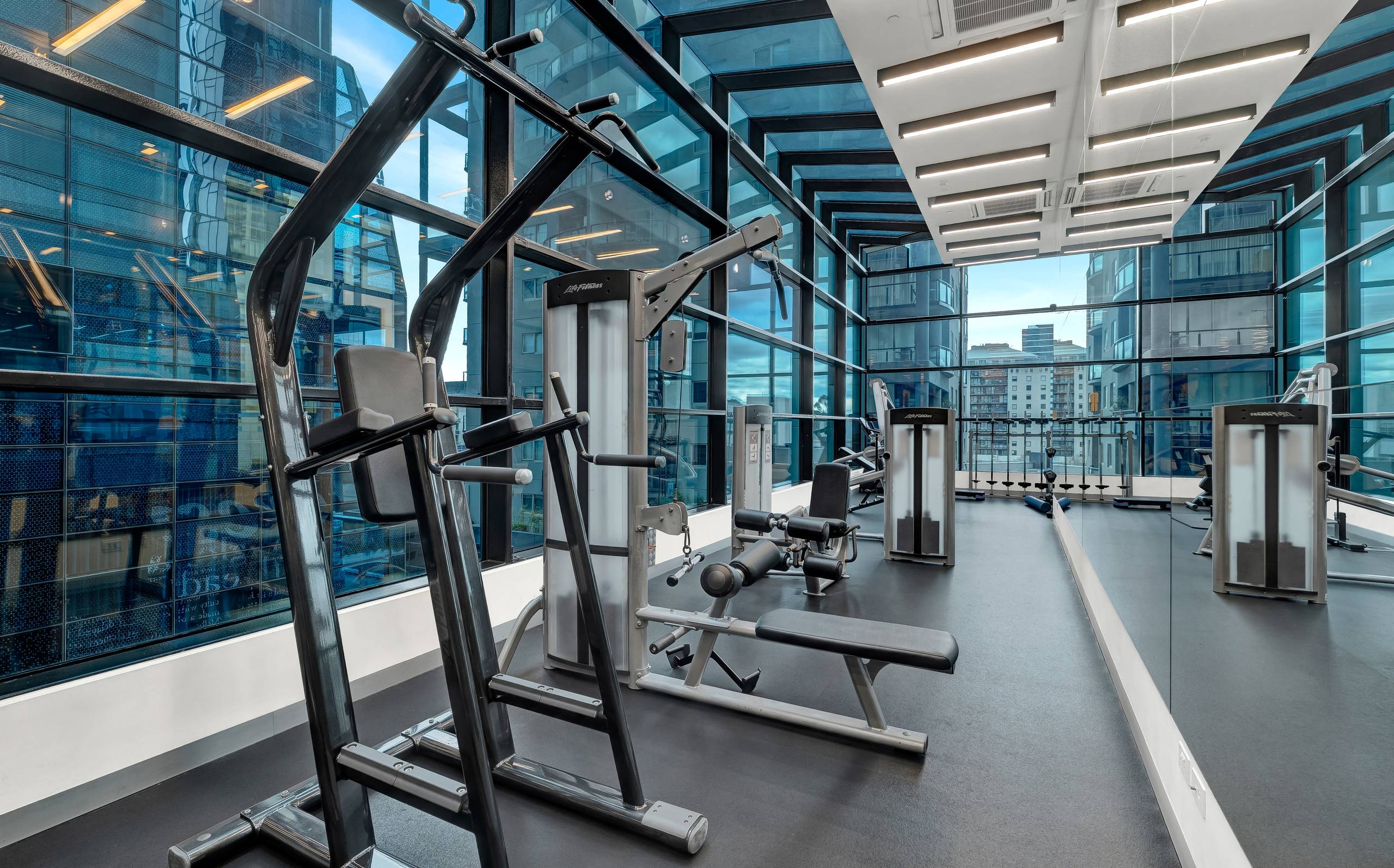 Aurora: gym — weights and machines behind floor-to-ceiling glass