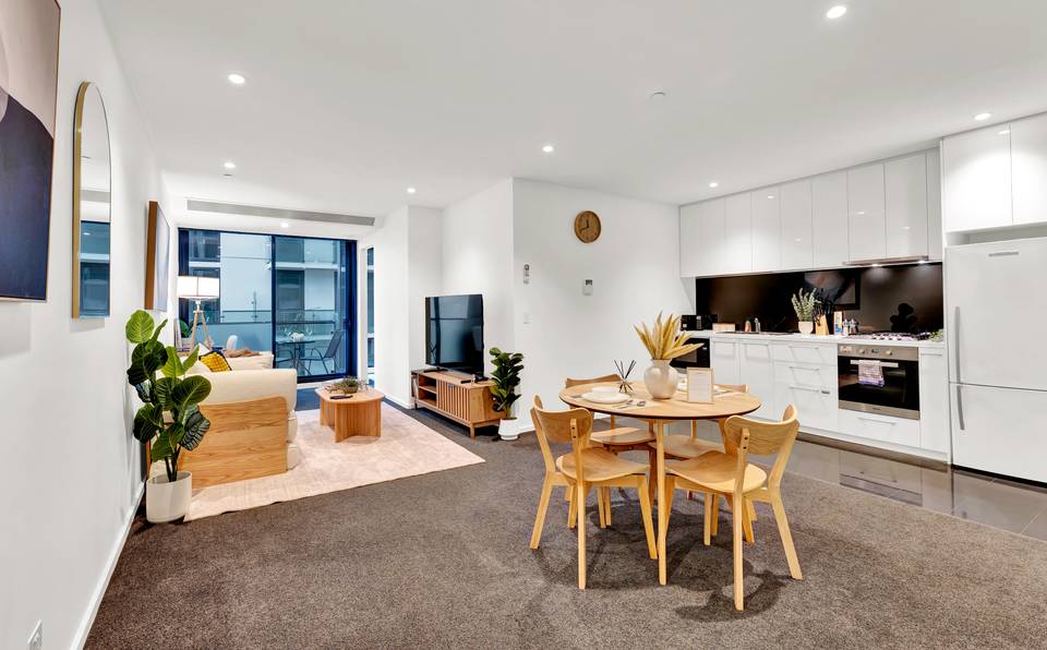 Aurora: living and dining — open-plan living, dining and a Miele kitchen, with the balcony and the city beyond