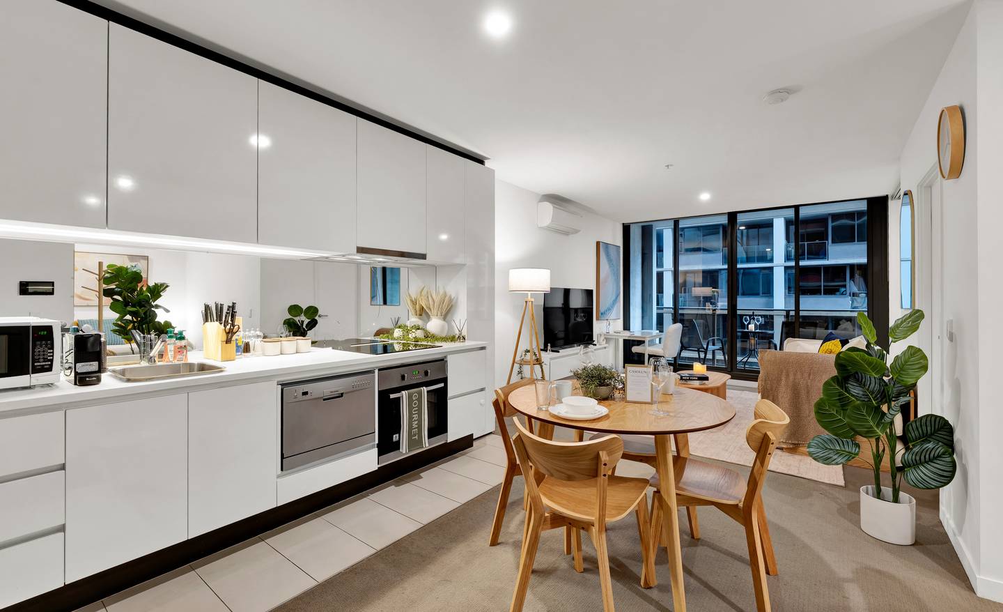 Madison: living and dining — cook, dine and relax in one bright open-plan room, with the balcony beyond
