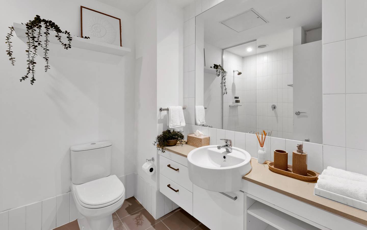 Spencer: bathroom — a walk-in shower with a shower curtain, hotel-grade towels and starter toiletries ready on arrival