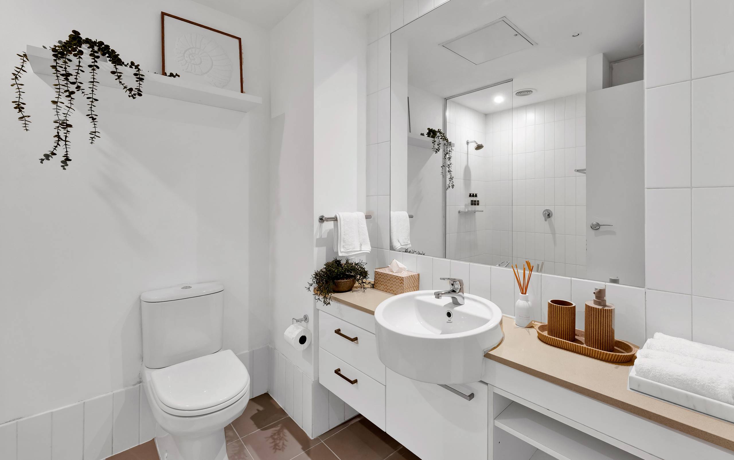Spencer: bathroom — a walk-in shower with a shower curtain, hotel-grade towels and starter toiletries ready on arrival