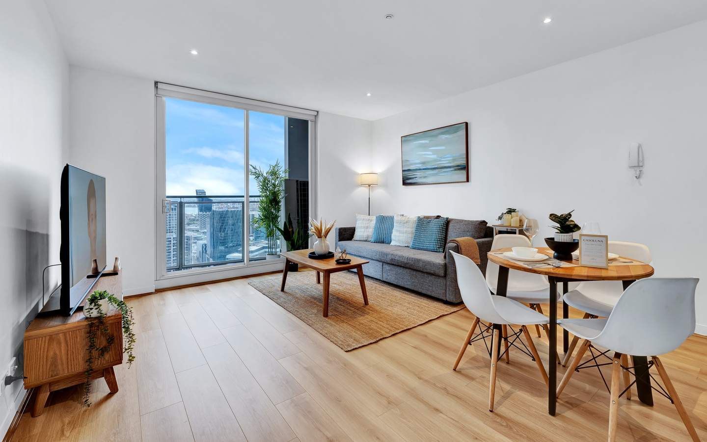Spencer: living and dining — relax on the sofa with the 65-inch smart TV, or dine at the round table for four